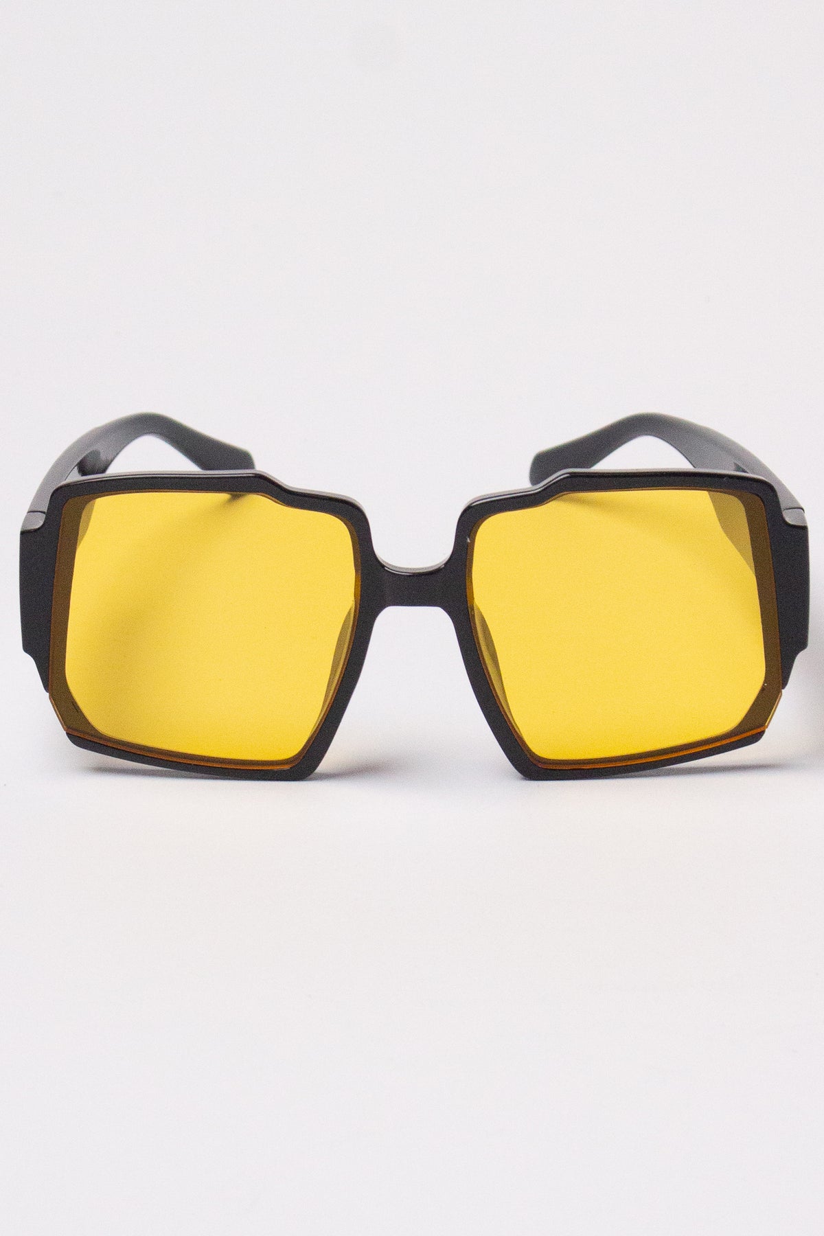 Black geometric sunglasses with bright yellow tinted lenses
