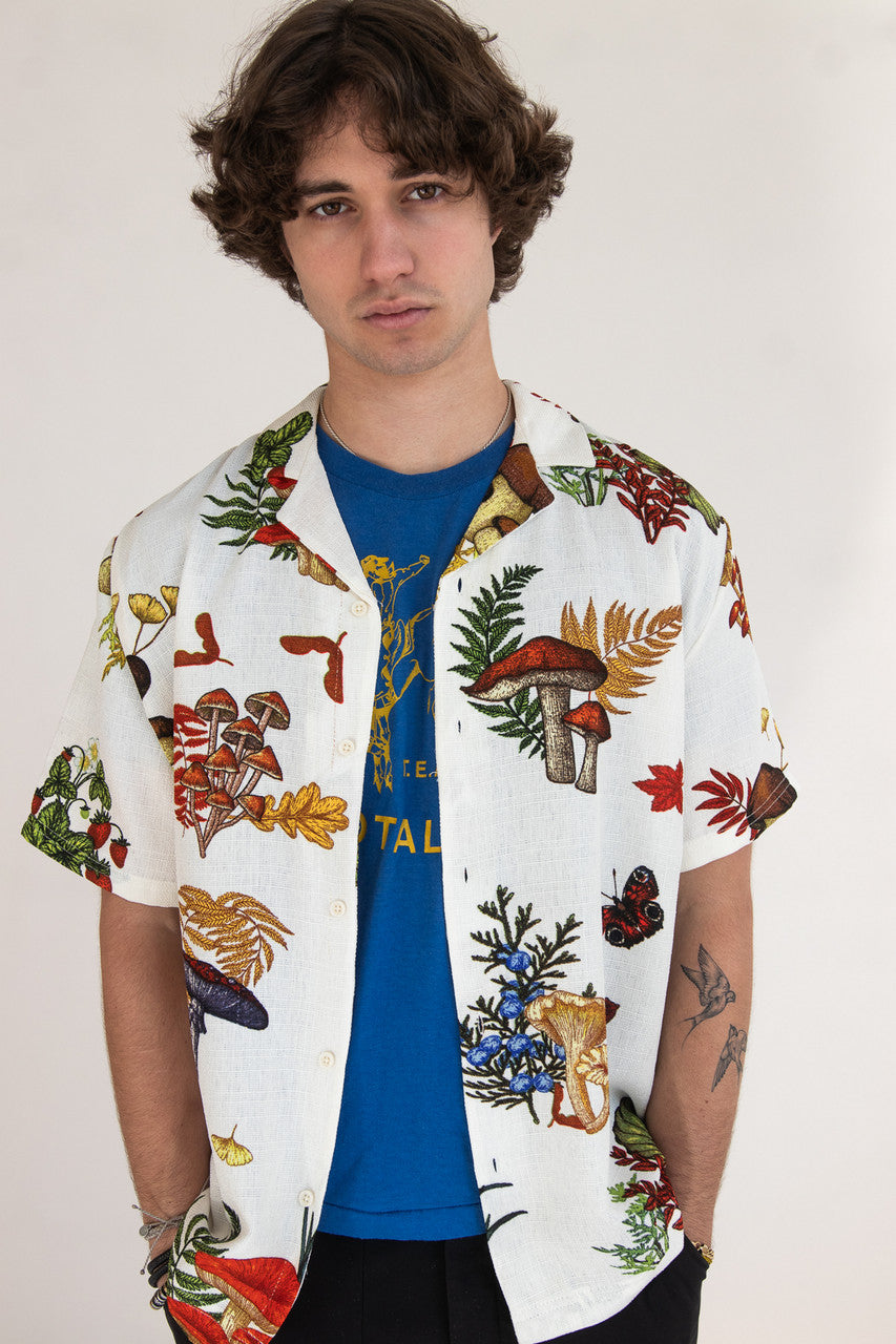 Man wearing white button up shirt with mushroom print pattern