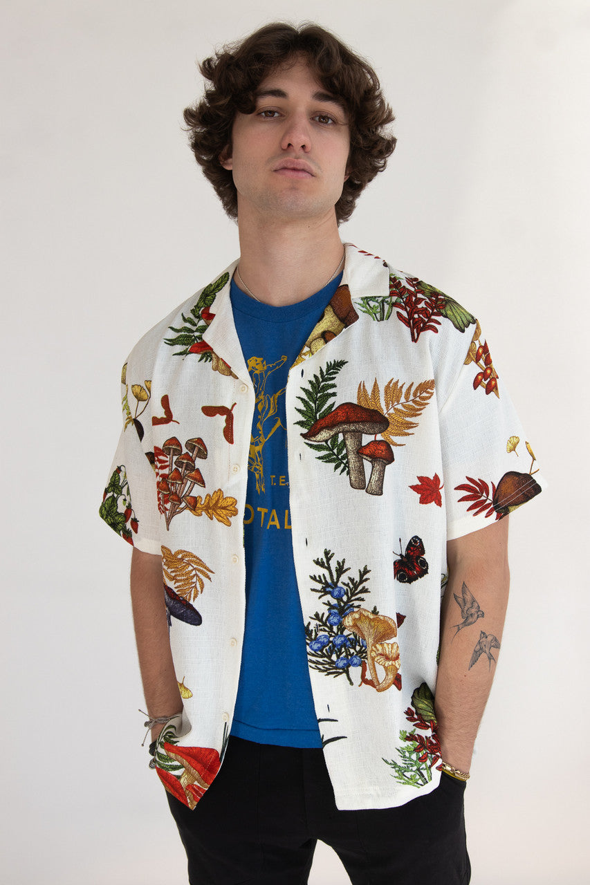 Man wearing white button up shirt with mushroom print pattern