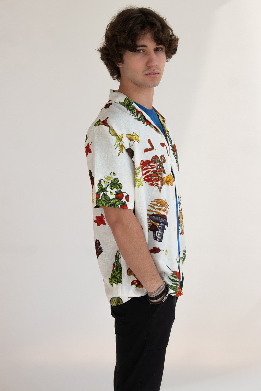 Man wearing white button up shirt with mushroom print pattern