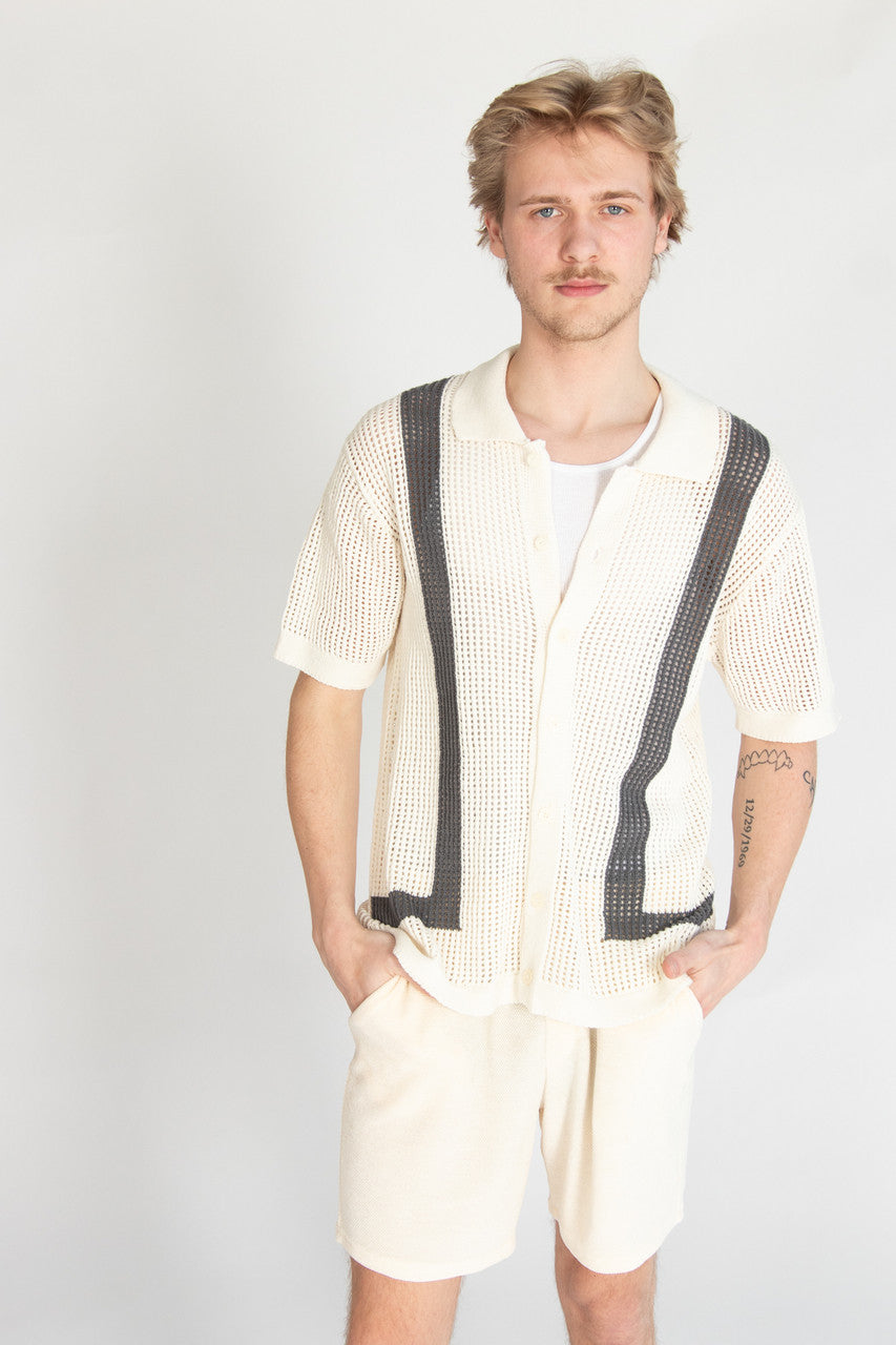 Man wearing a white crochet bowling style shirt