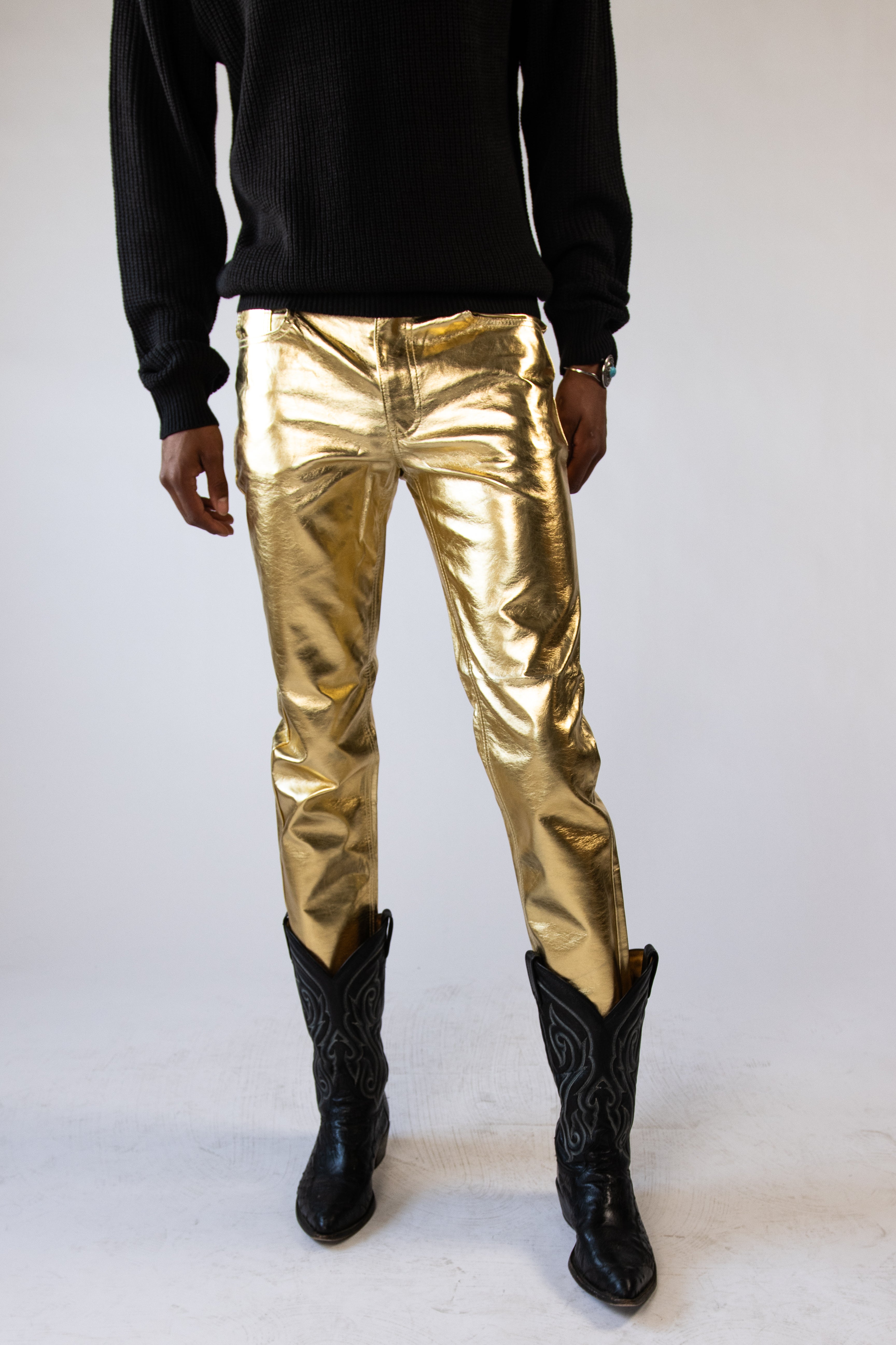 model wearing gold metallic jeans
