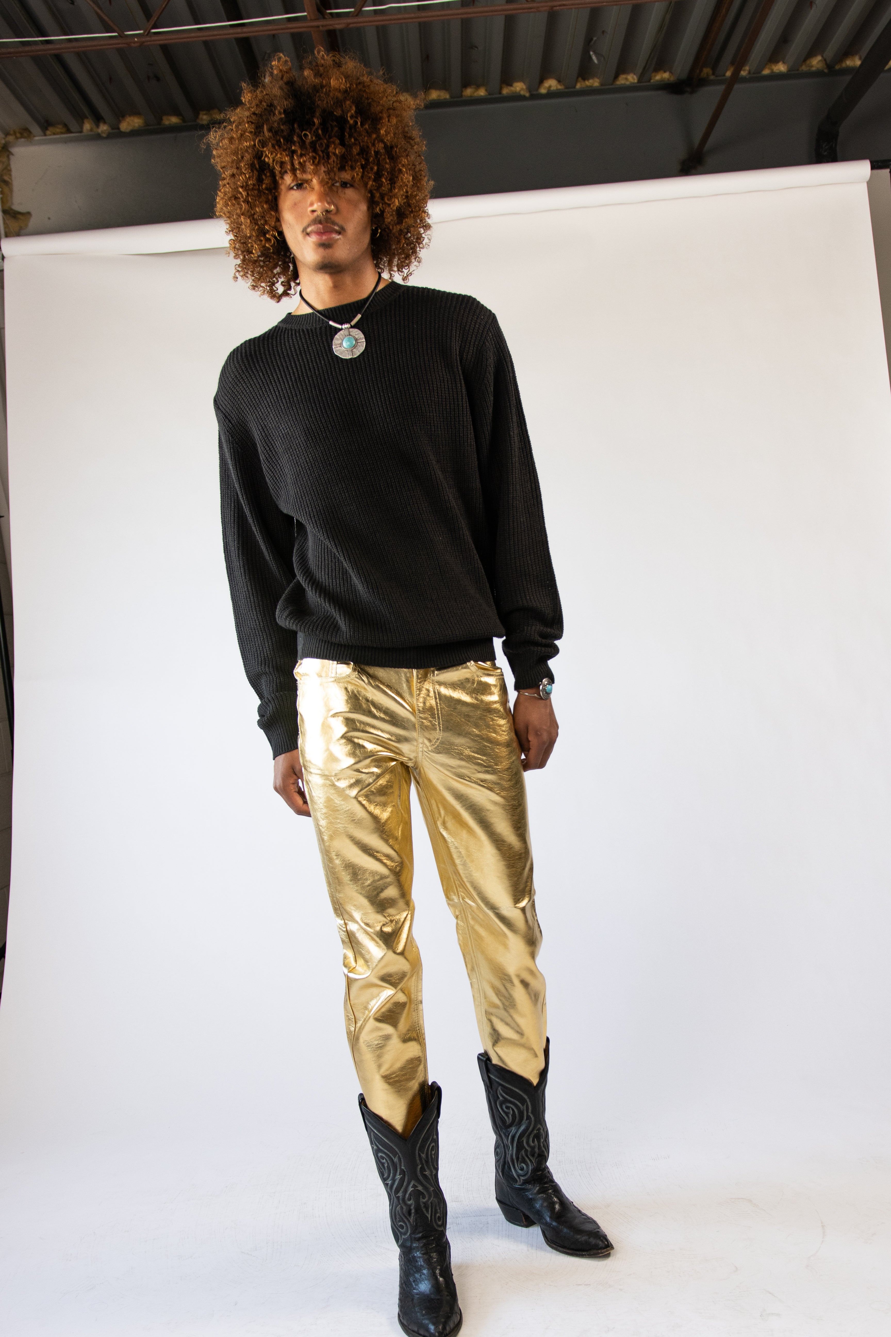 model wearing gold metallic jeans