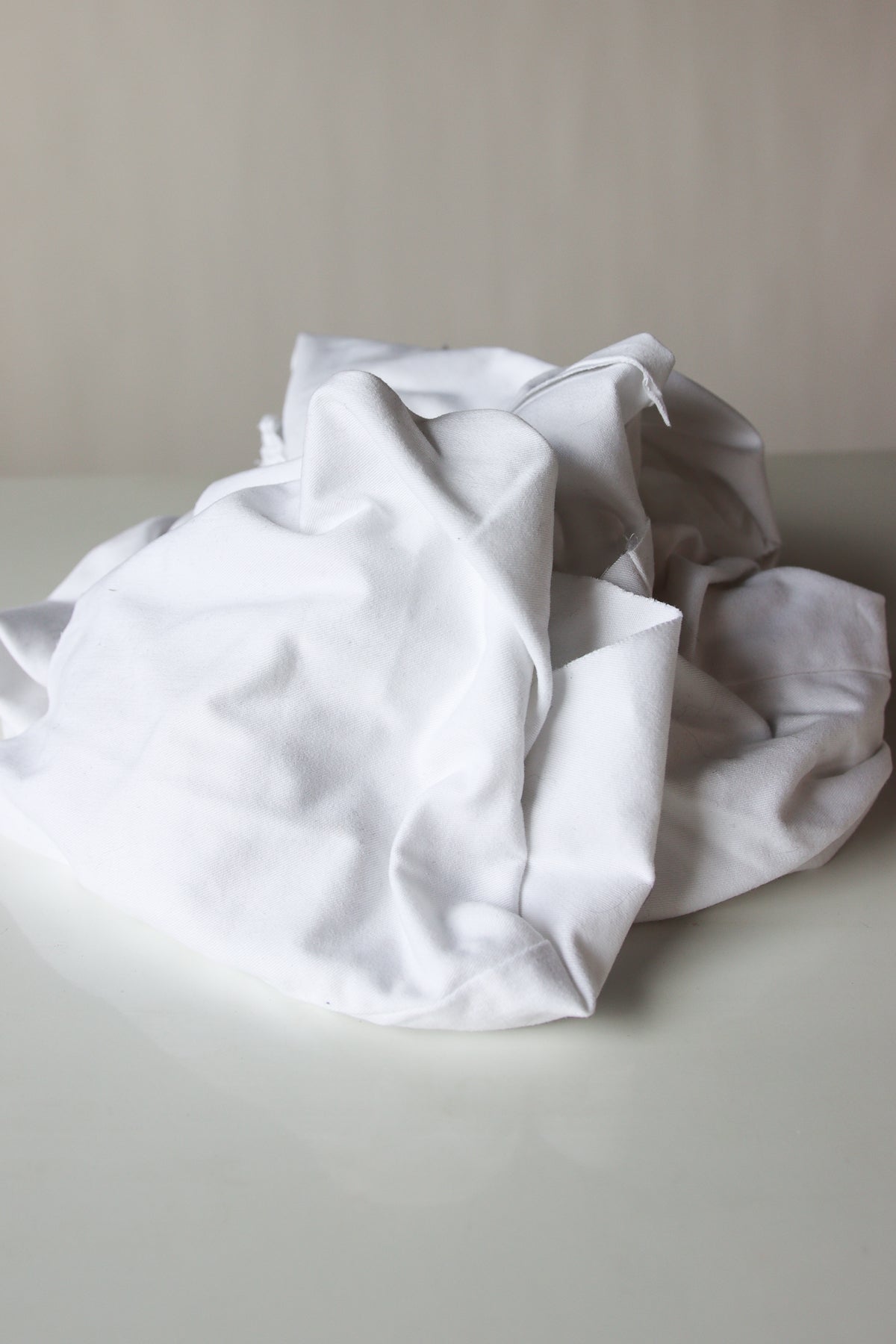 Piled assortment of mixed heavy white fabric wiping cloths