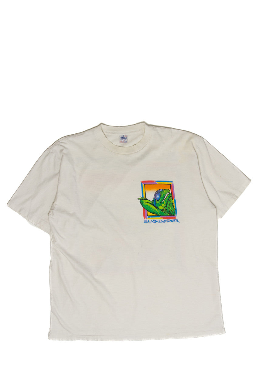 White vintage t-shirt featuring a colorful El Salvador lizard graphic on the front chest area.