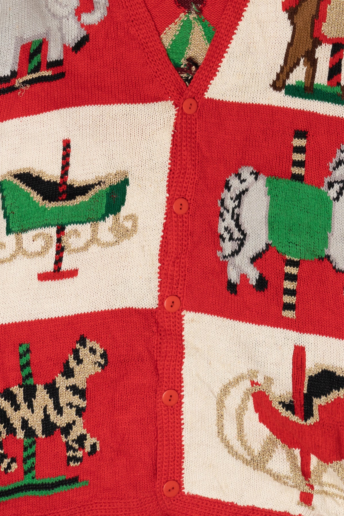Red cardigan with colorful animal illustrations on a red background