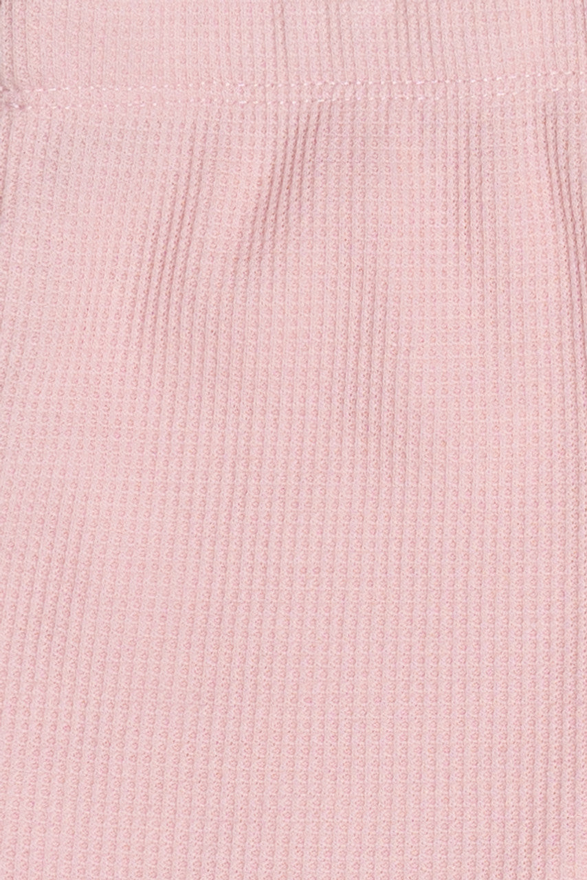 Close-up of soft pink thermal fabric texture from Thermal Dolphin Shorts showing ribbed knit detail