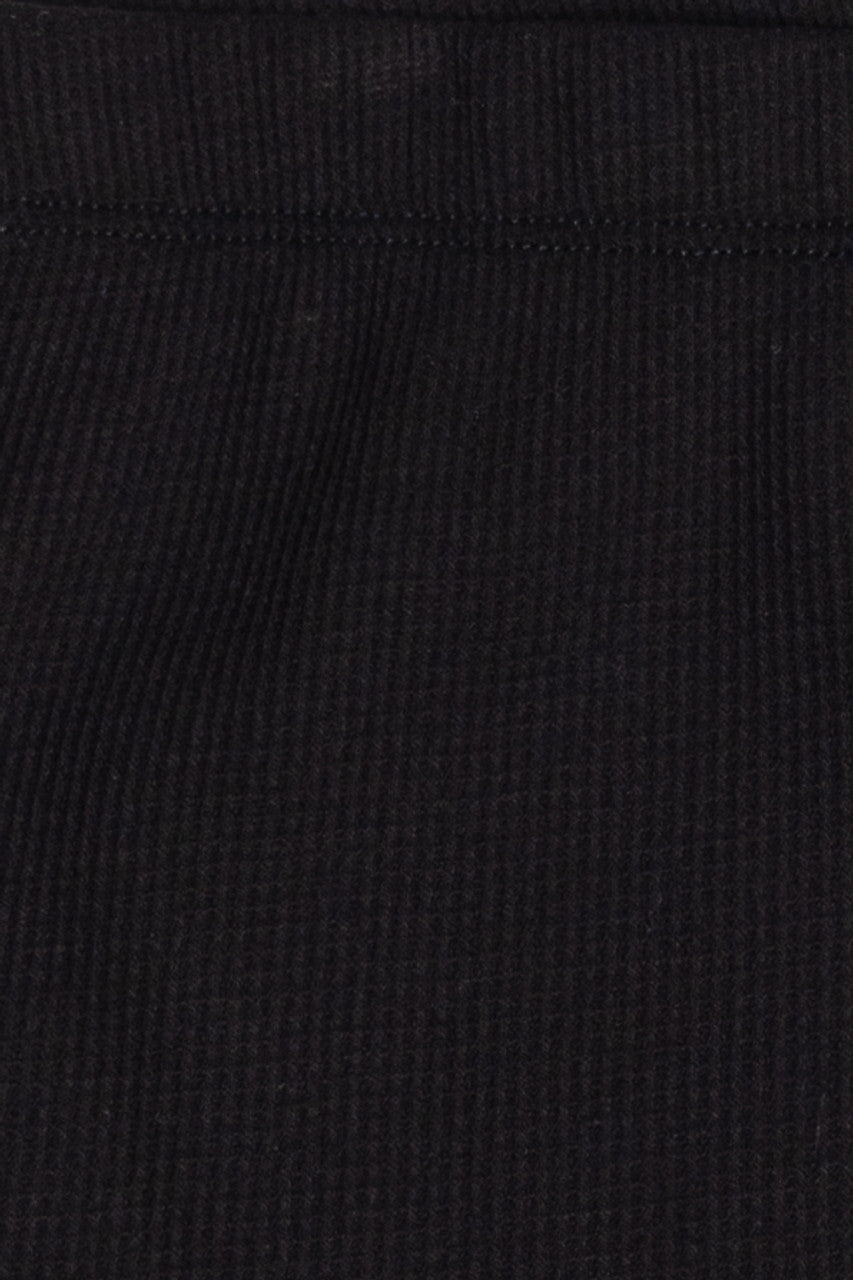 Close-up of black thermal fabric texture on Dolphin Shorts showing ribbed knit design and stitching detail