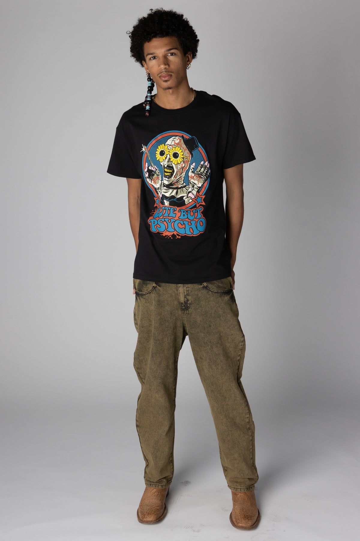 Black T-shirt featuring Art the Clown graphic with sunflower glasses and Cute But Psycho text