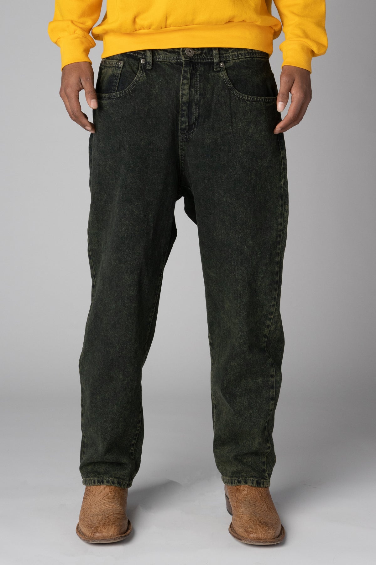 Men's relaxed-fit acid-wash charcoal denim jeans paired with brown leather boots