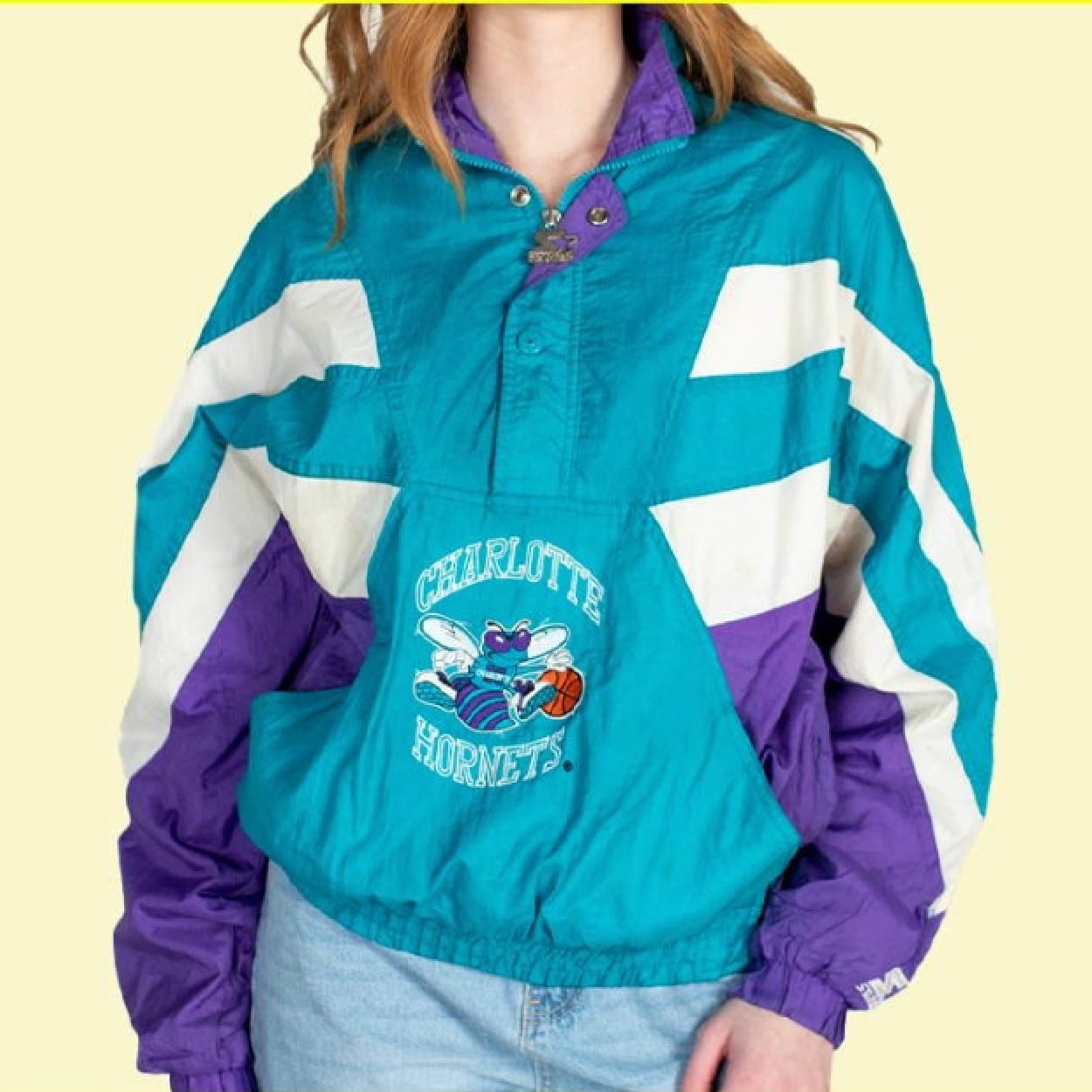 Teal Charlotte Hornets 90's windbreaker with bold purple and white panels.