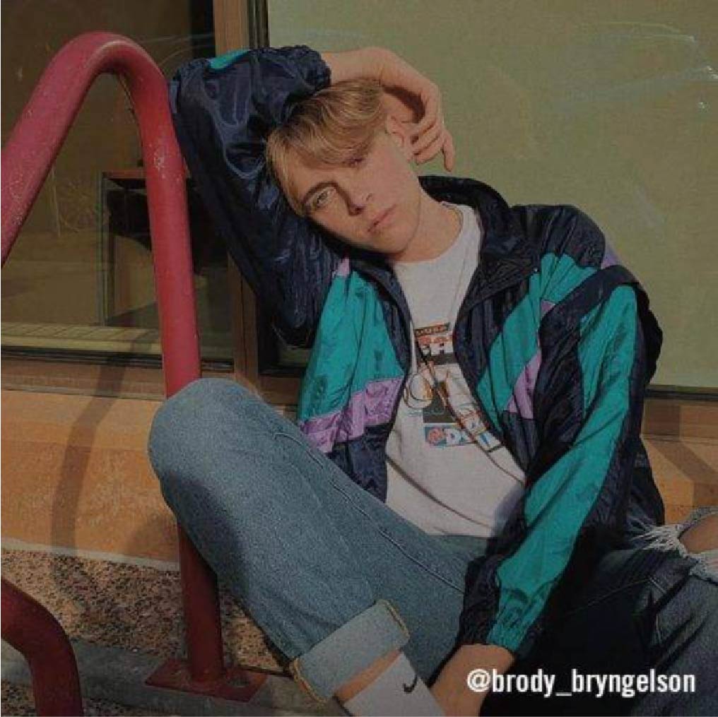 @brody_bryngelson in a 90's casual fit with light-wash denim, a color-block windbreaker, and a vintage graphic tee–a comfortable and classic 90's look