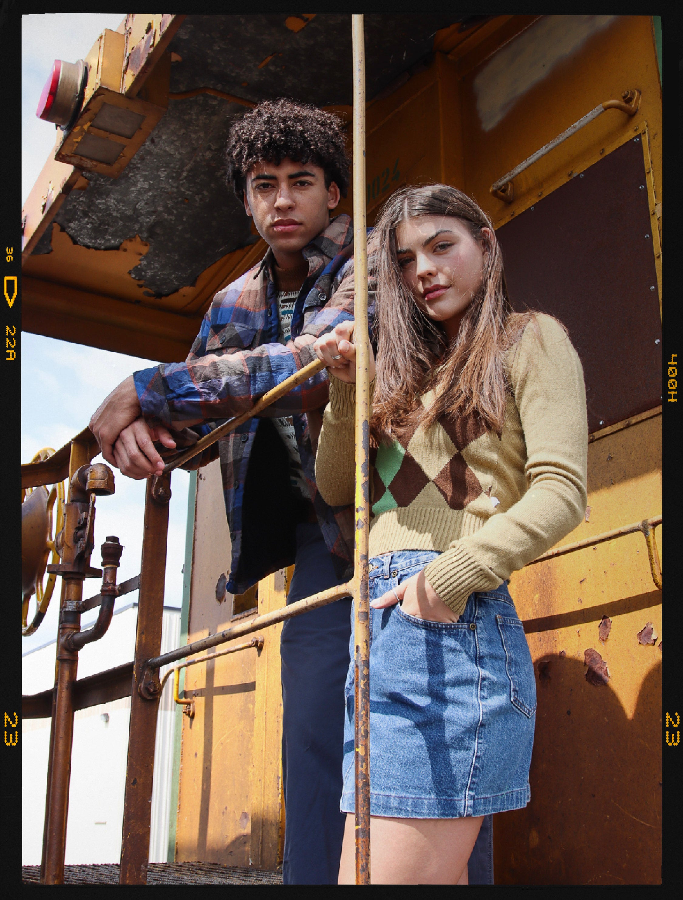 two models wearing fall vintage fashion. A flannel shirt and vintage y2k sweater