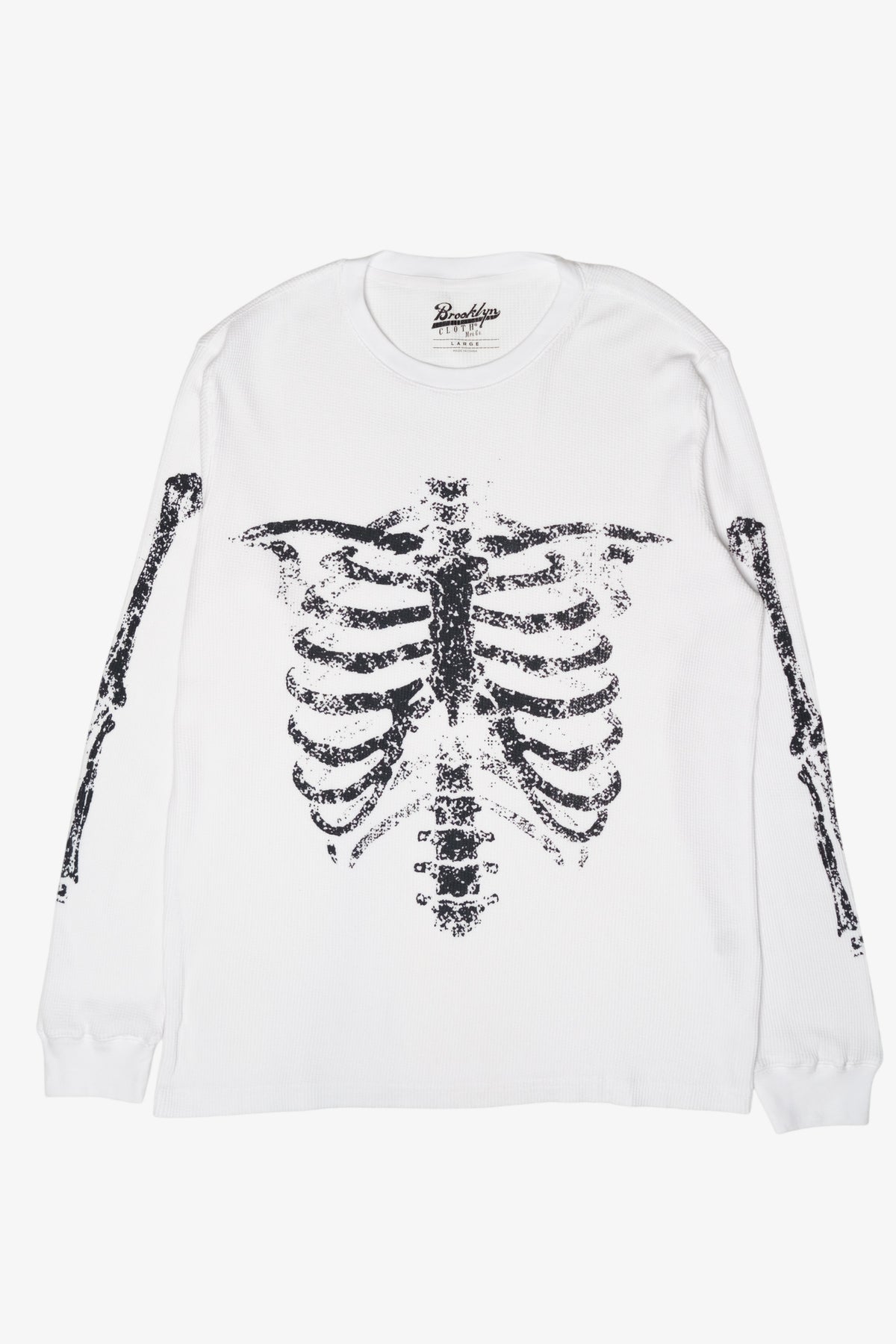 White long-sleeve thermal shirt with black distressed skeleton rib cage and arm bone graphics