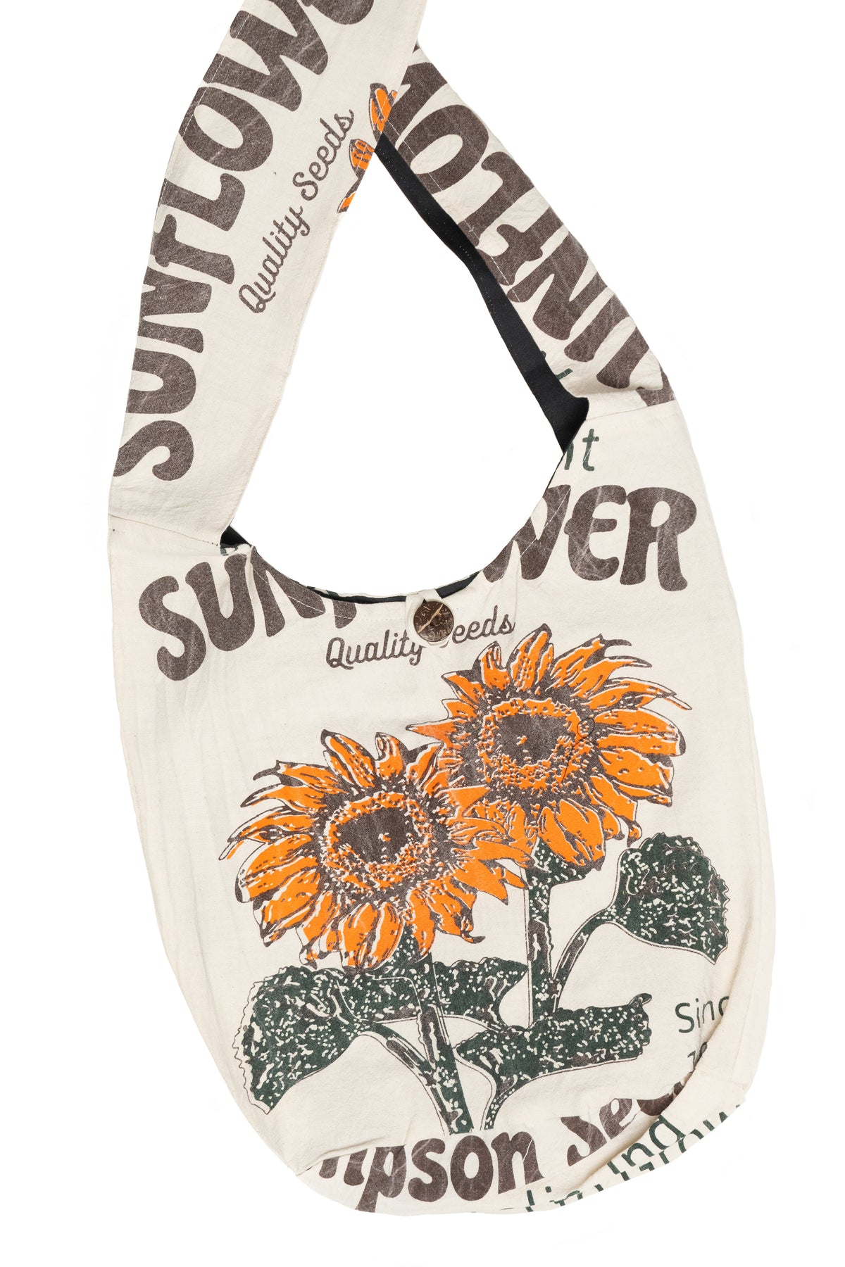 A canvas shoulder bag featuring a vintage-style sunflower seed print. The bag has a cream-colored background with brown text reading 'SUNFLOWER Quality Seeds' and a graphic of two orange and yellow sunflowers with green leaves.