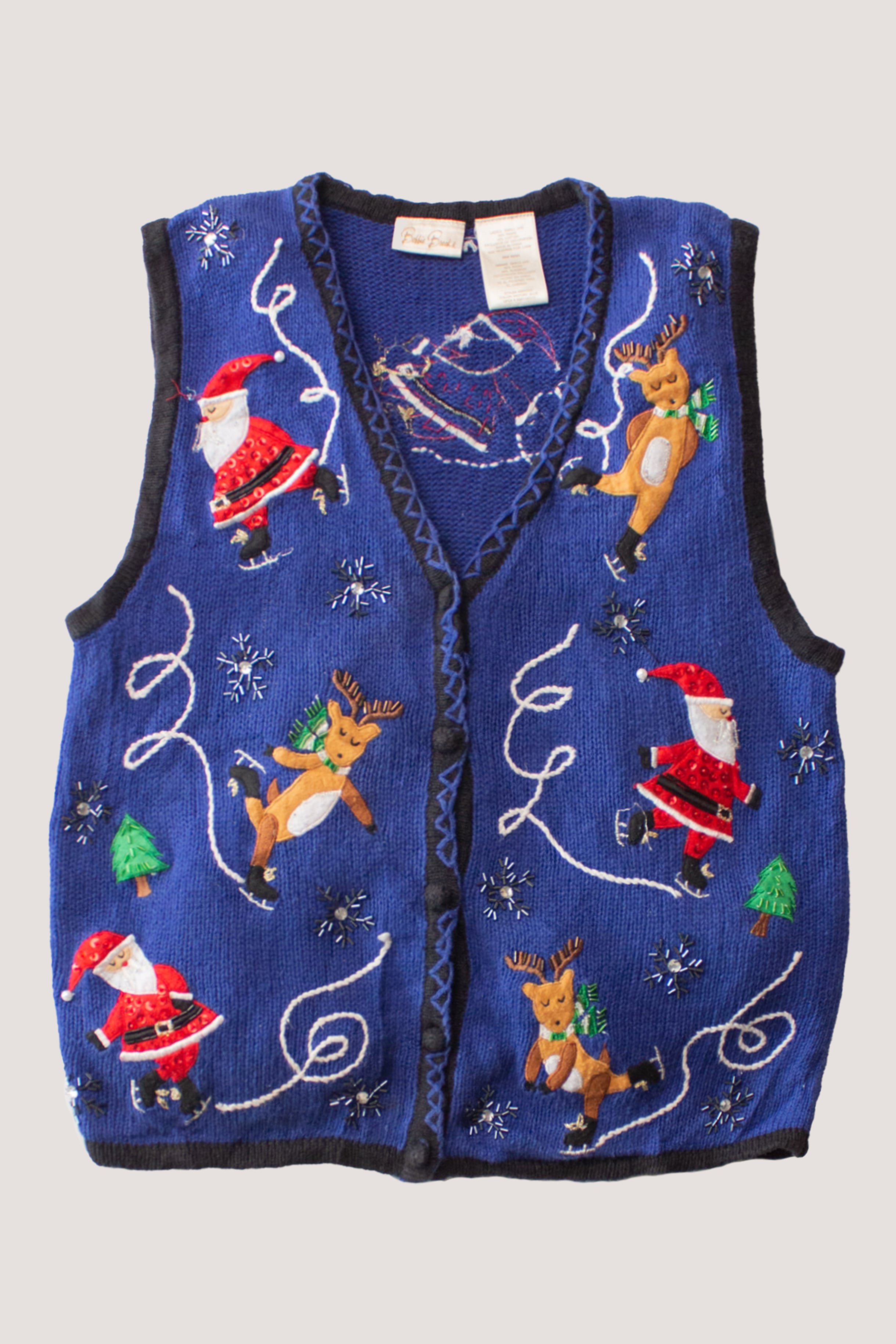 Vintage blue Christmas sweater vest with Santa, reindeer, snowflakes, and tree holiday designs in various colors