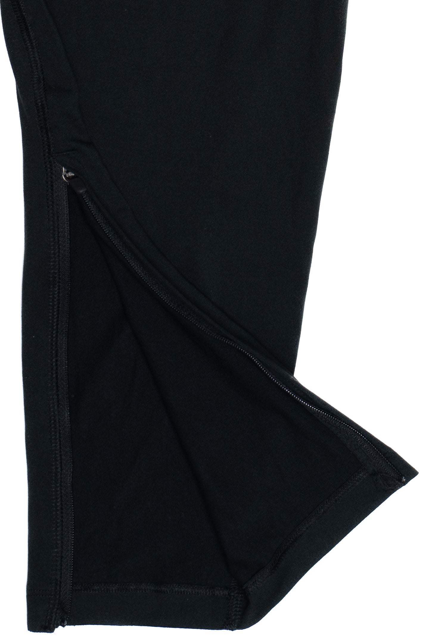 Close-up of black Nike Dri-FIT San Francisco track pants showing ankle zipper detail and fabric texture