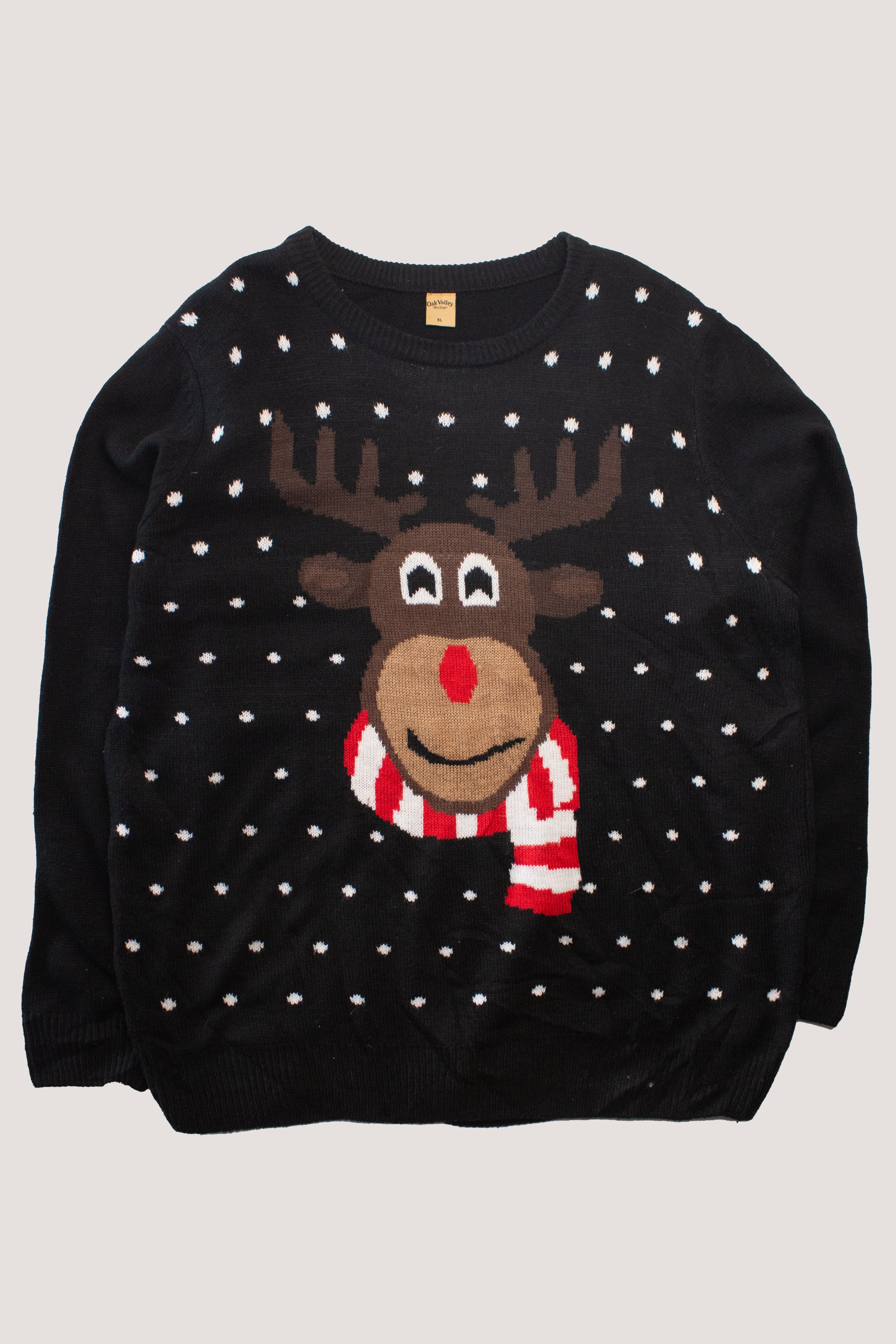 Black oversized recycled Christmas sweater with smiling reindeer and white snowflake pattern