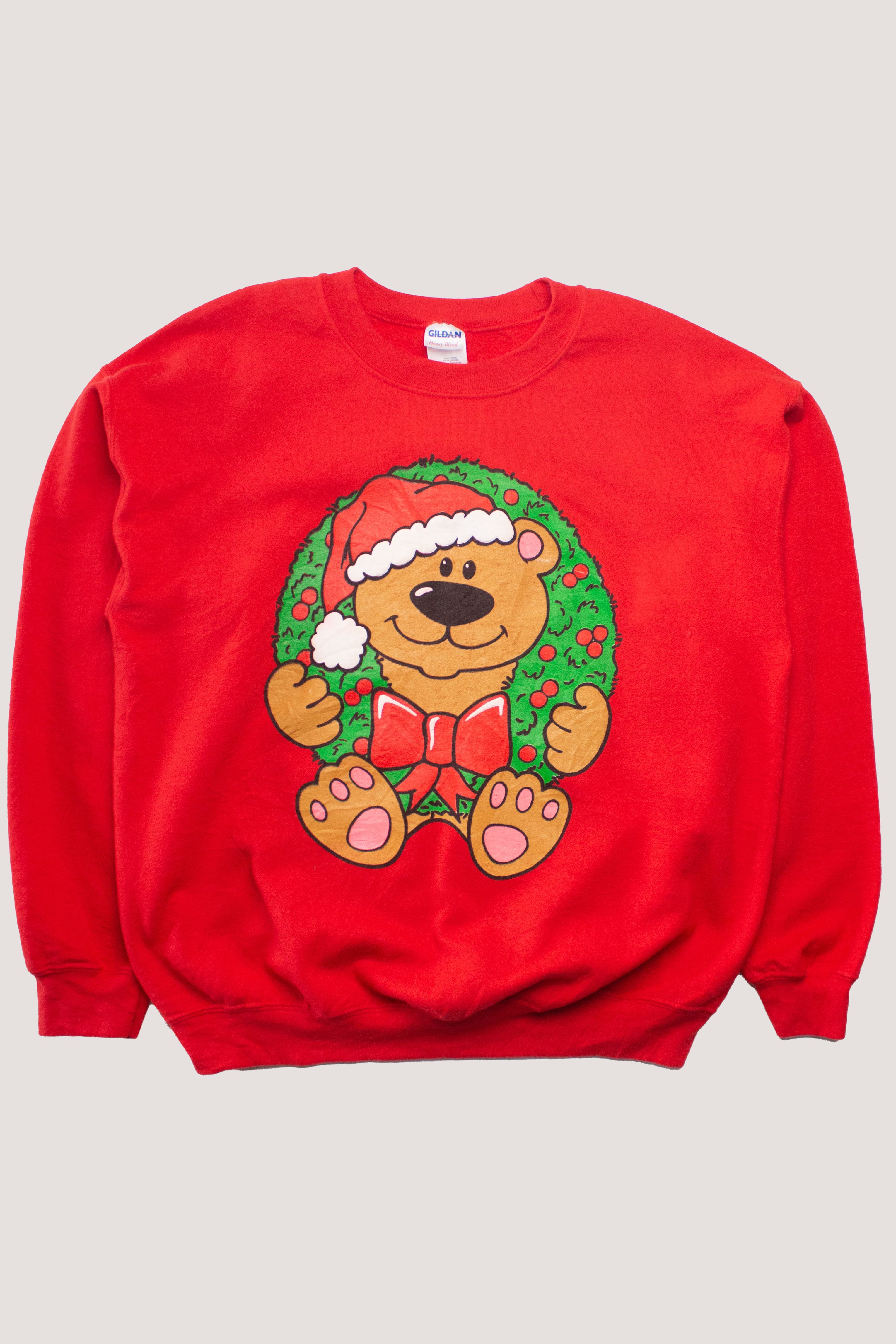 Red vintage Christmas sweatshirt featuring a teddy bear wearing a Santa hat and wreath design on front