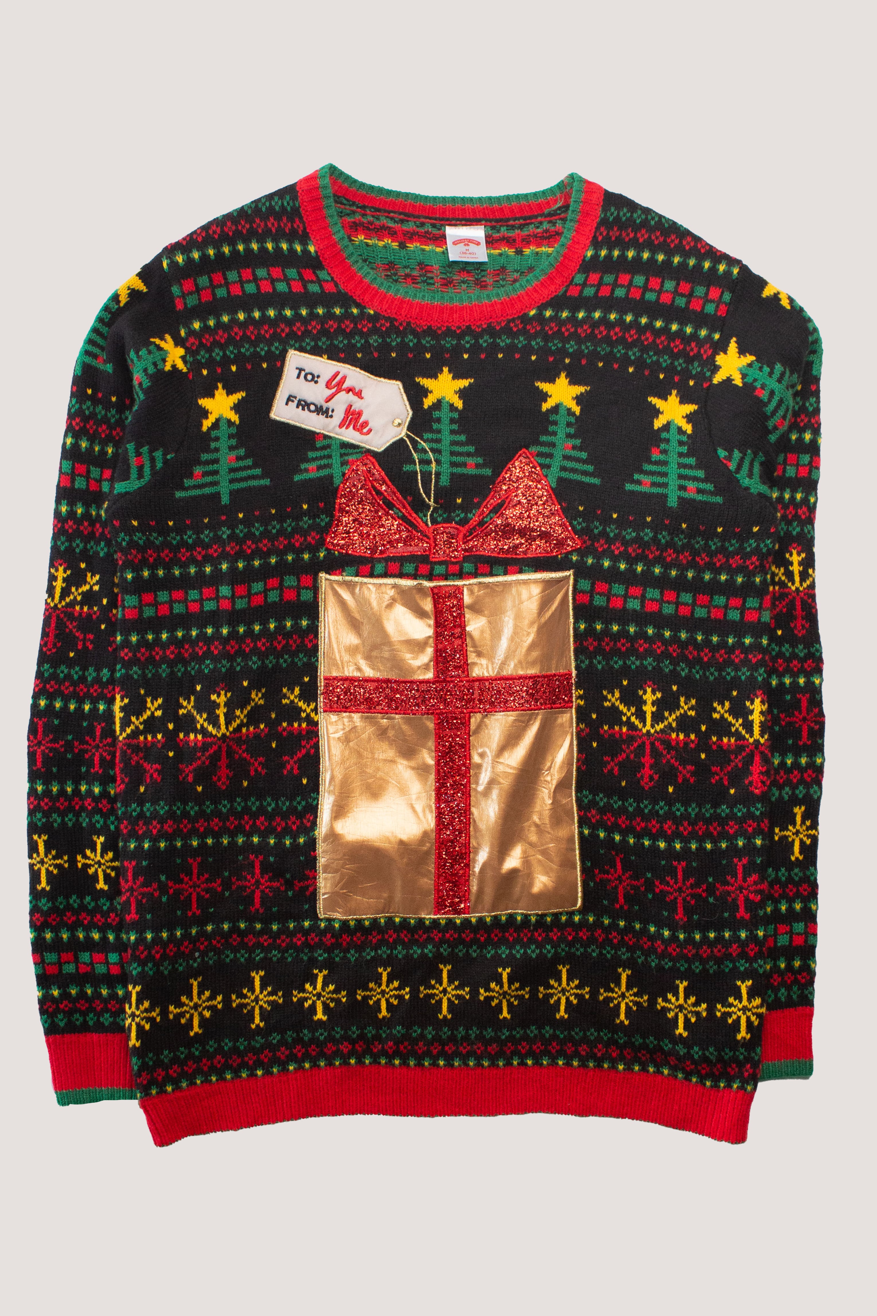 Colorful recycled ugly Christmas sweater with gift design, trees, stars, and festive red and green patterns for women