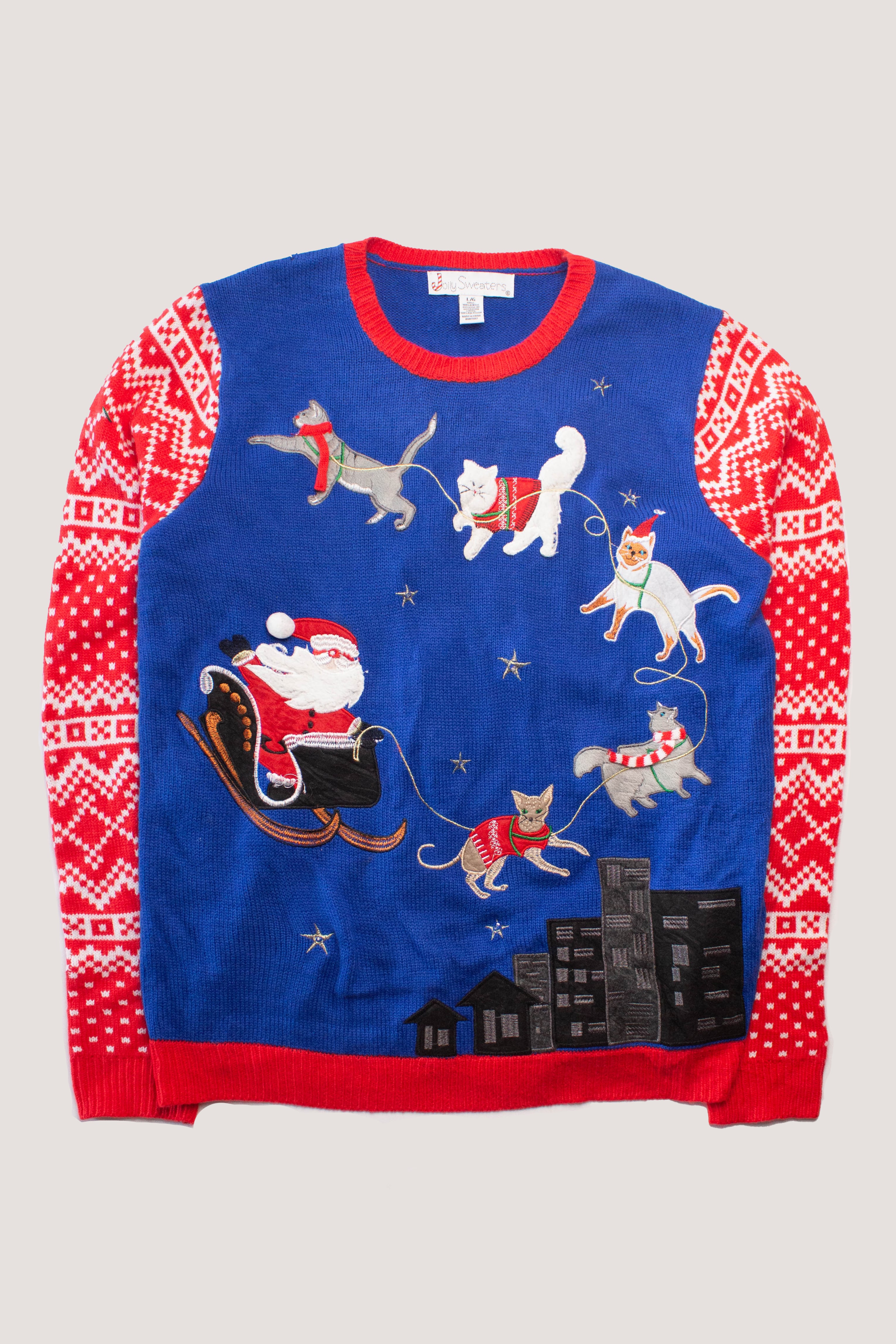 Blue and red ugly Christmas sweater with Santa in sleigh pulled by cats wearing festive sweaters