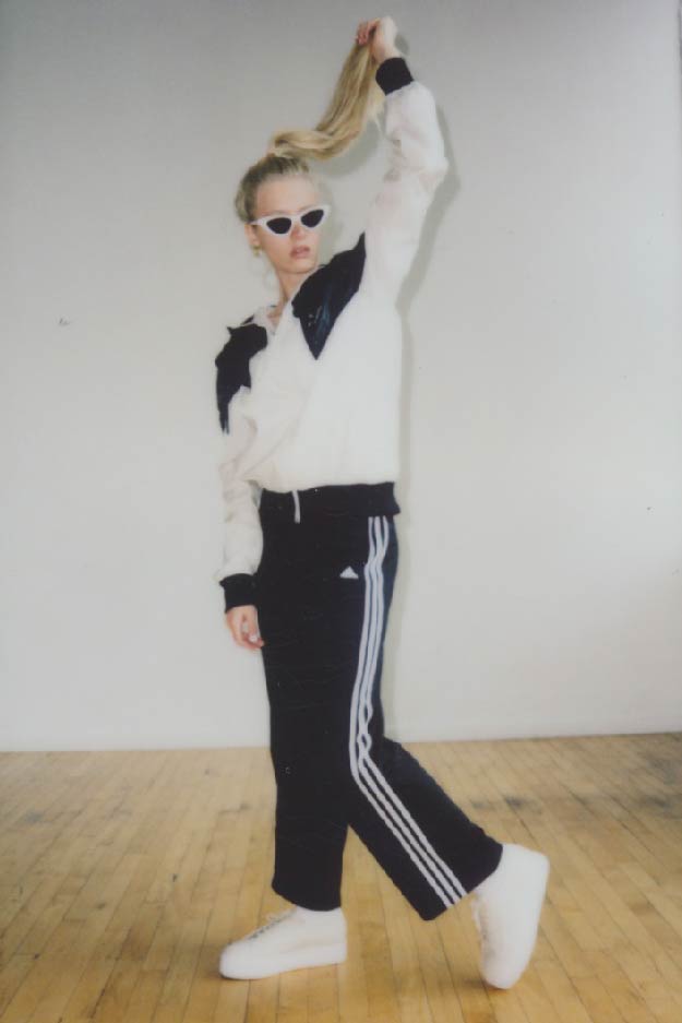 female model wearing vintage adidas track pants