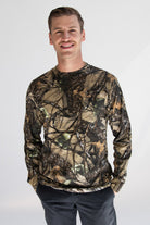 Man wearing woodland print camo long sleeve t-shirt