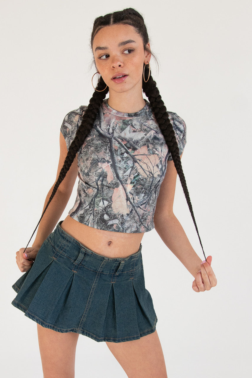 Woman wearing woodland print t-shirt and denim skirt