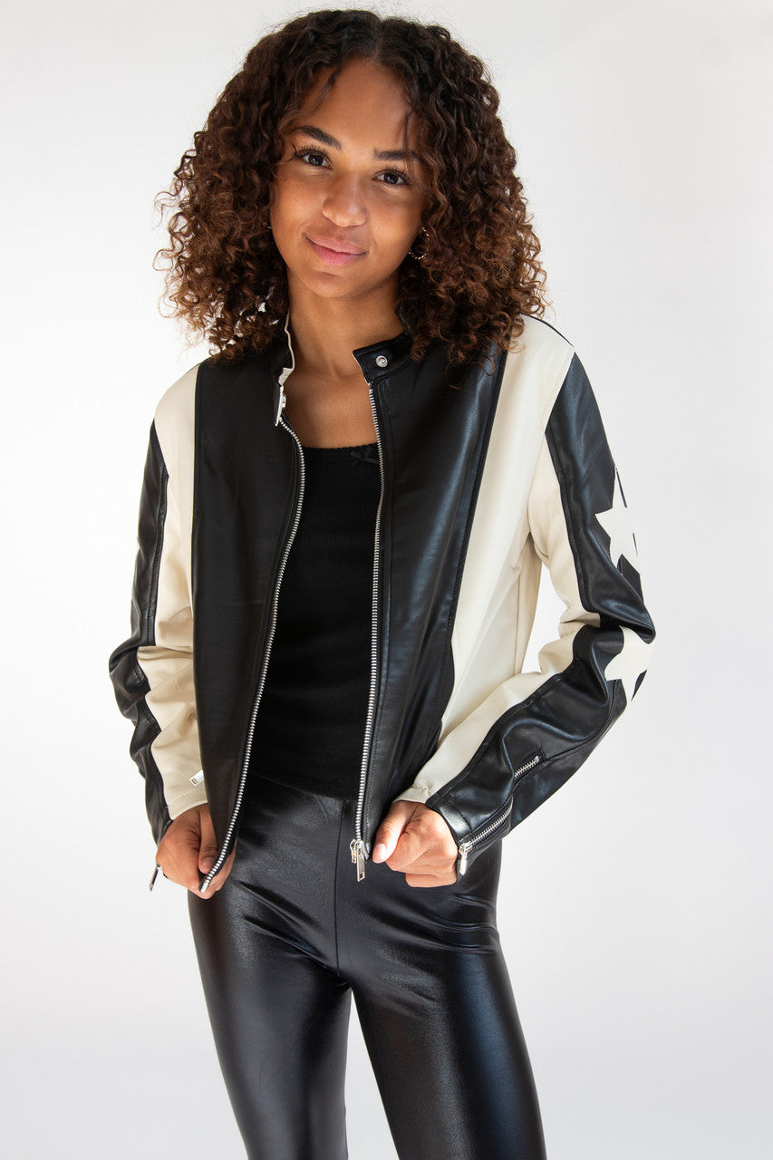 Woman wearing black and white leather jacket with star on sleeve
