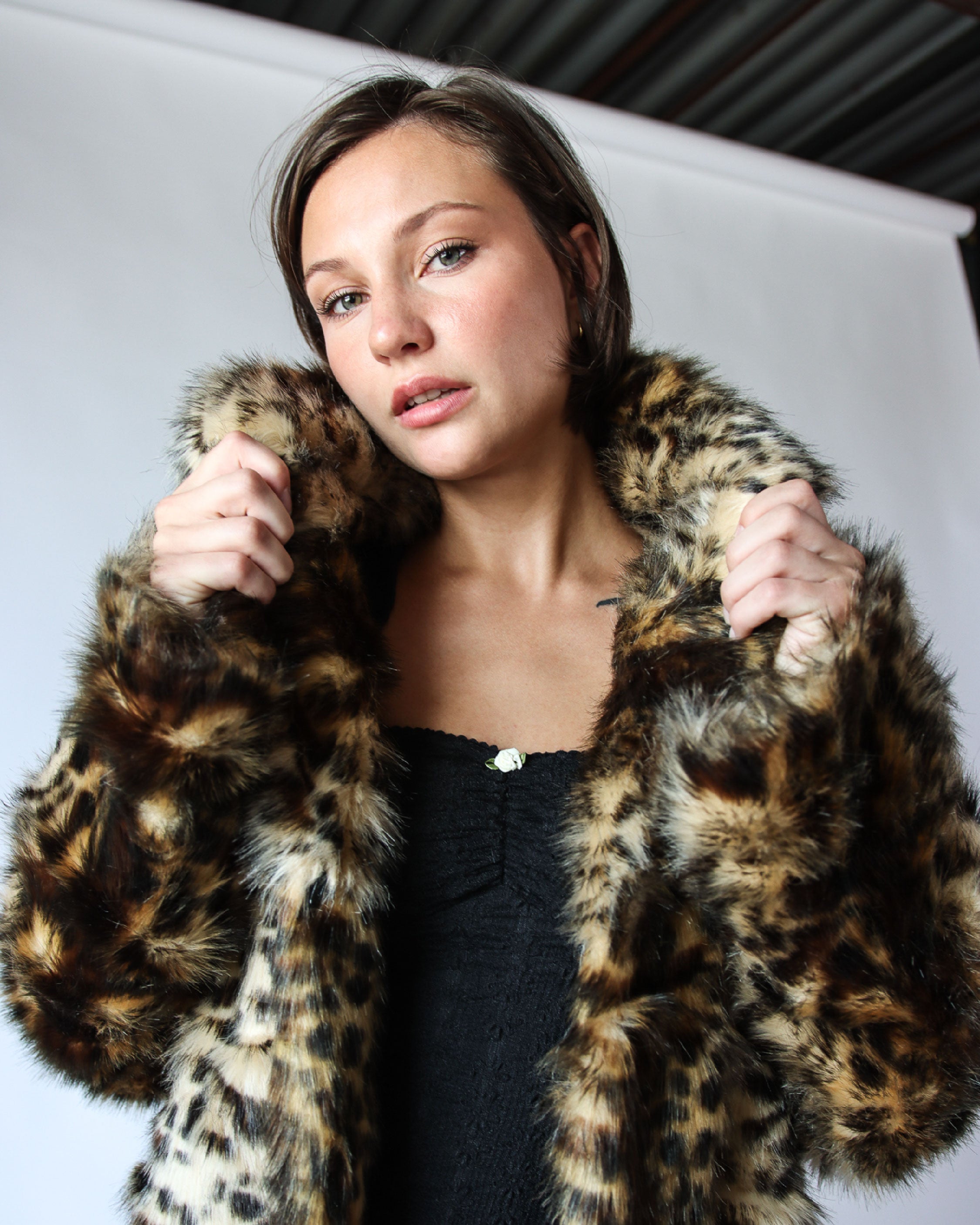 female model wearing vintage cheetah print faux fur coat