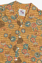 Patterned shirt with a visible brand label on a yellow background