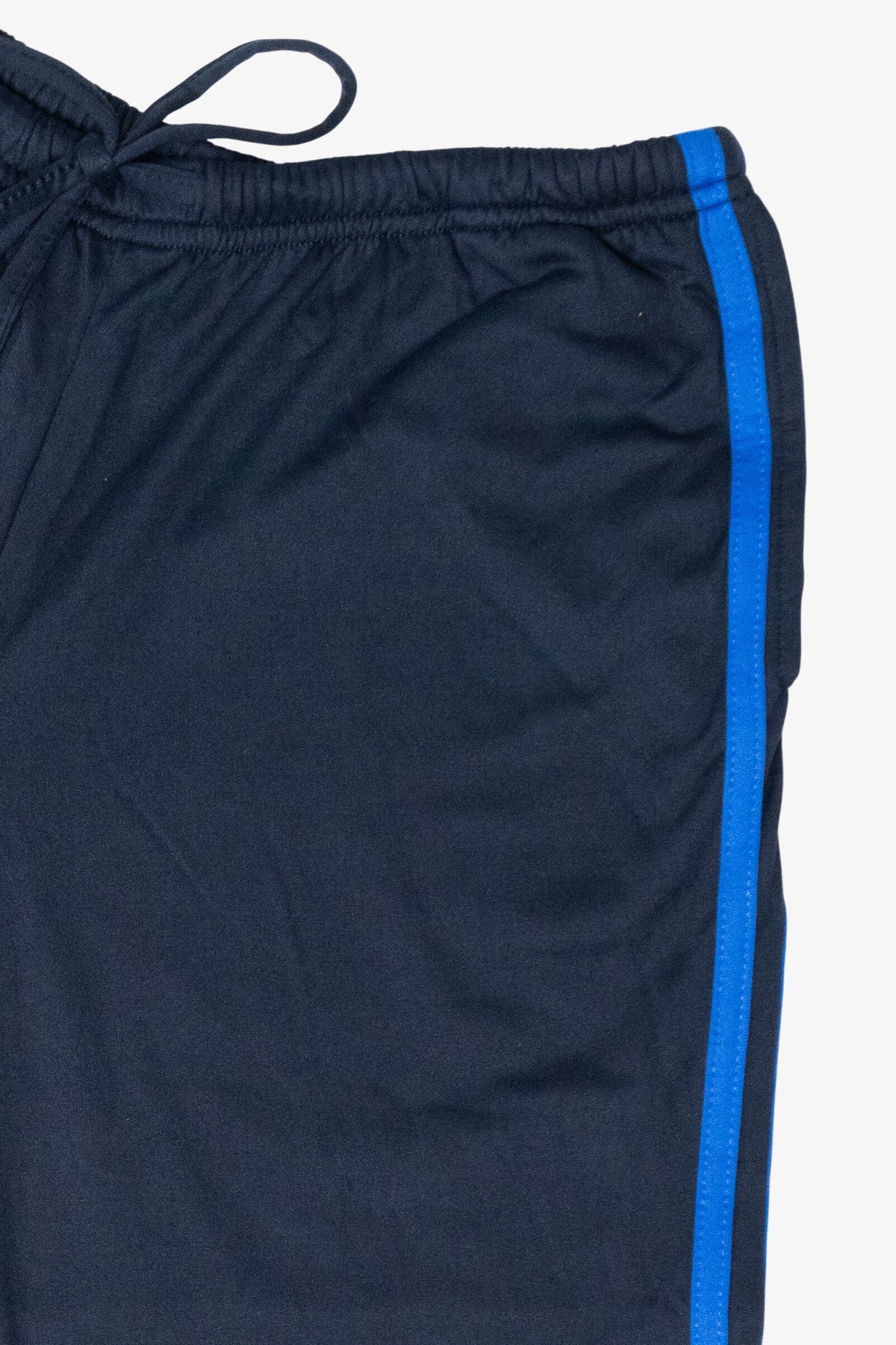 Close-up of navy athletic pants featuring an elastic drawstring waistband and a bright blue side stripe