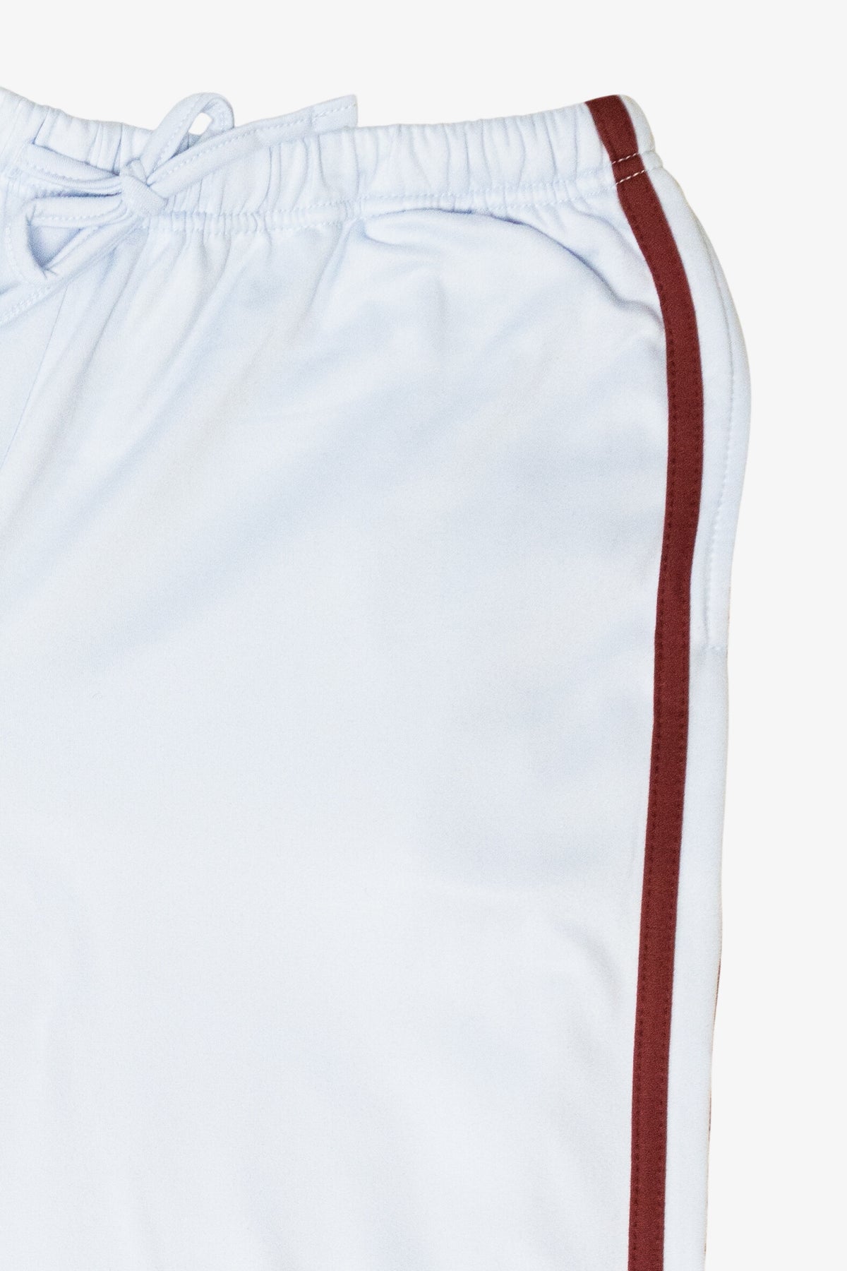 Close-up of white drawstring shorts featuring a burgundy side stripe