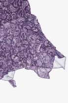 Close-up of purple paisley mesh fabric with ruffled handkerchief hem