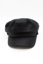 Black pebbled leather newsboy cap with a curved visor on a white background