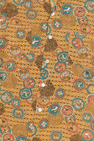 Patterned fabric with circular designs on a brown background