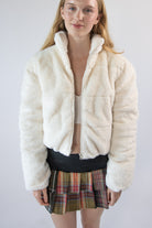 Woman wearing an off-white plush faux fur cropped puffer jacket