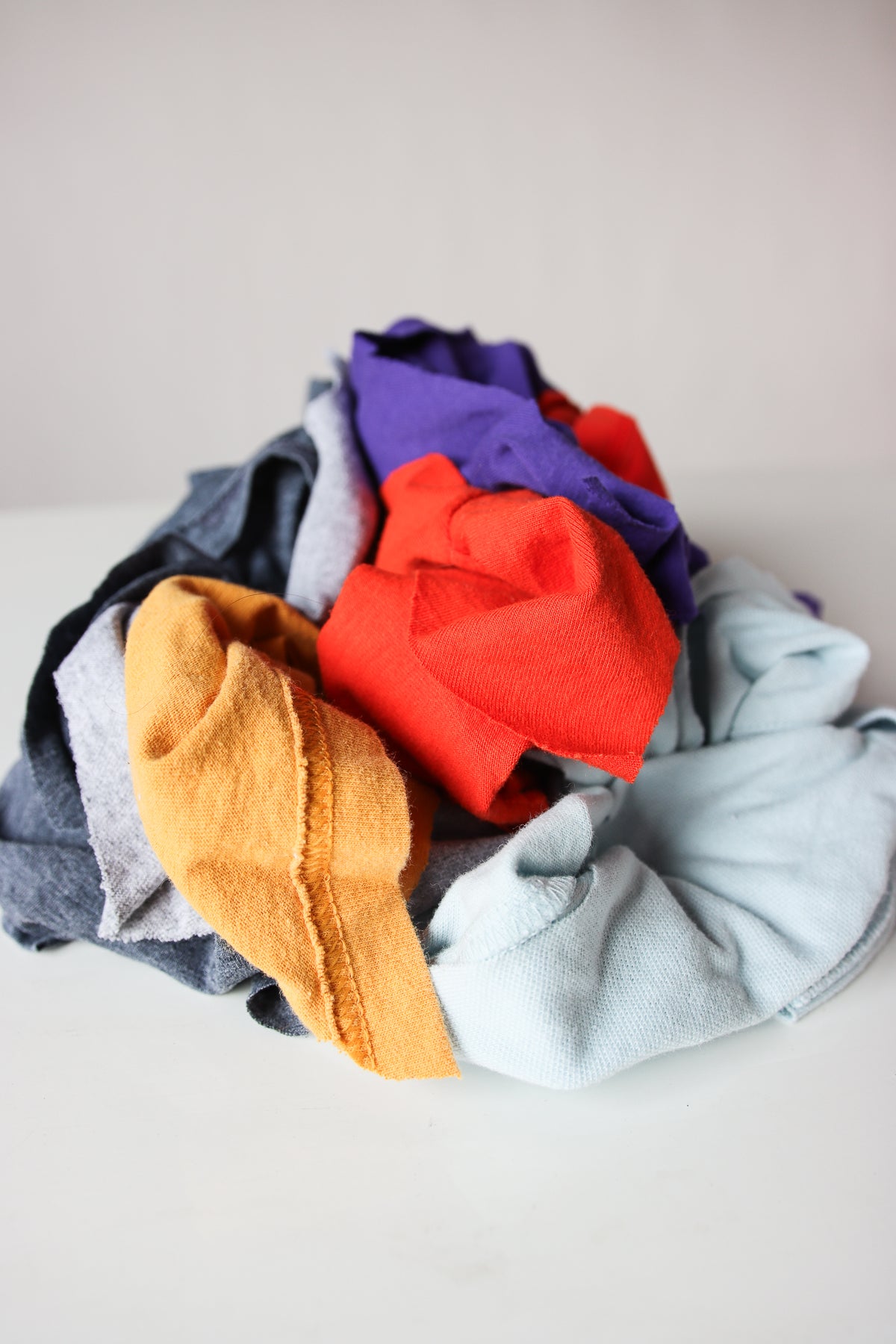 Piled assortment of mixed cotton polo fabric wiping cloths