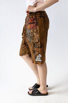 Person wearing a patterned skirt on a white background