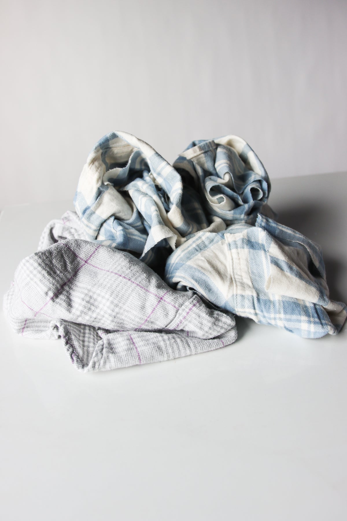 Piled assortment of mixed flannel fabric wiping cloths