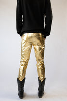 model wearing gold metallic jeans