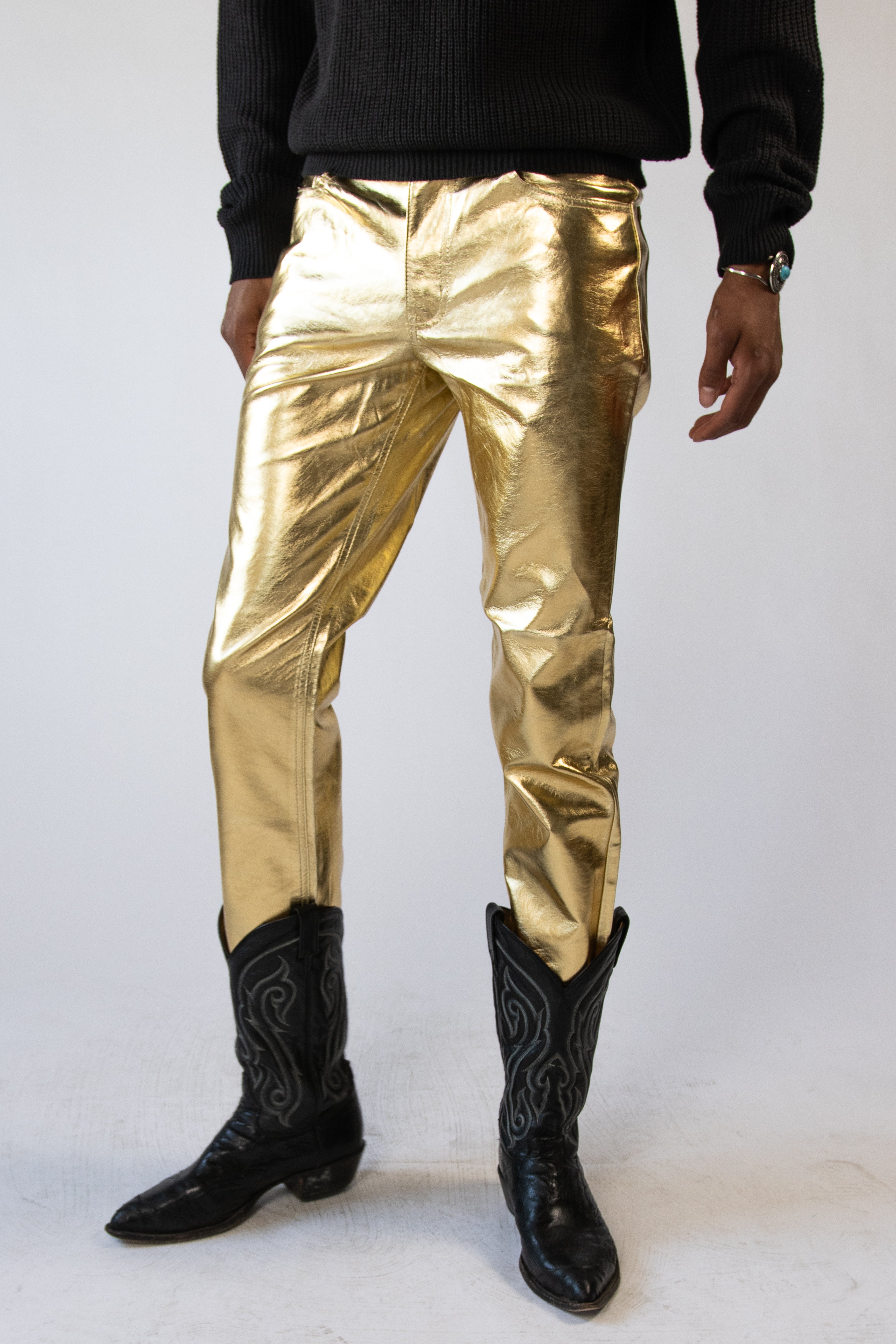 model wearing gold metallic jeans