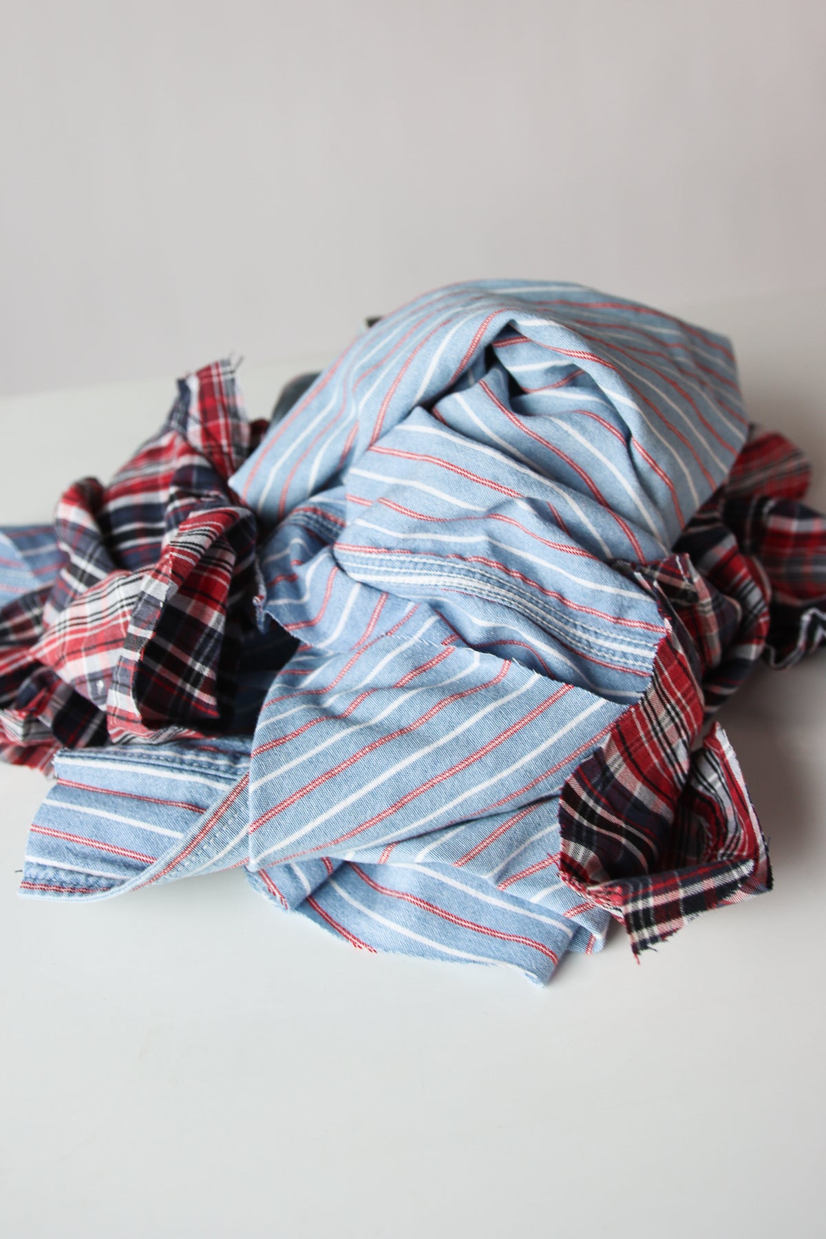 Piled assortment of mixed near white fabric wiping cloths