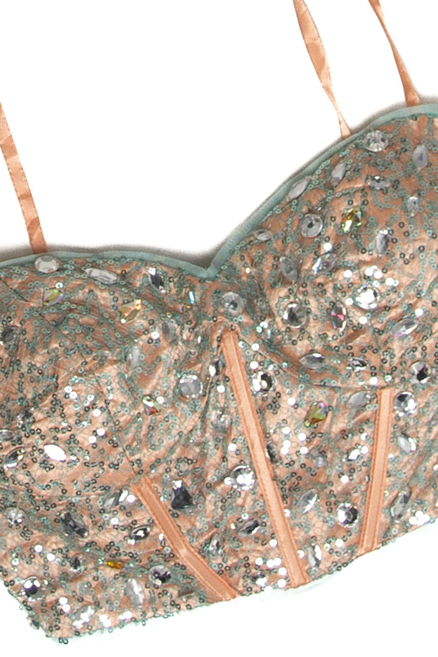 Close-up of vintage Blondie corset top with peach fabric and intricate silver sequin embellishments and rhinestones