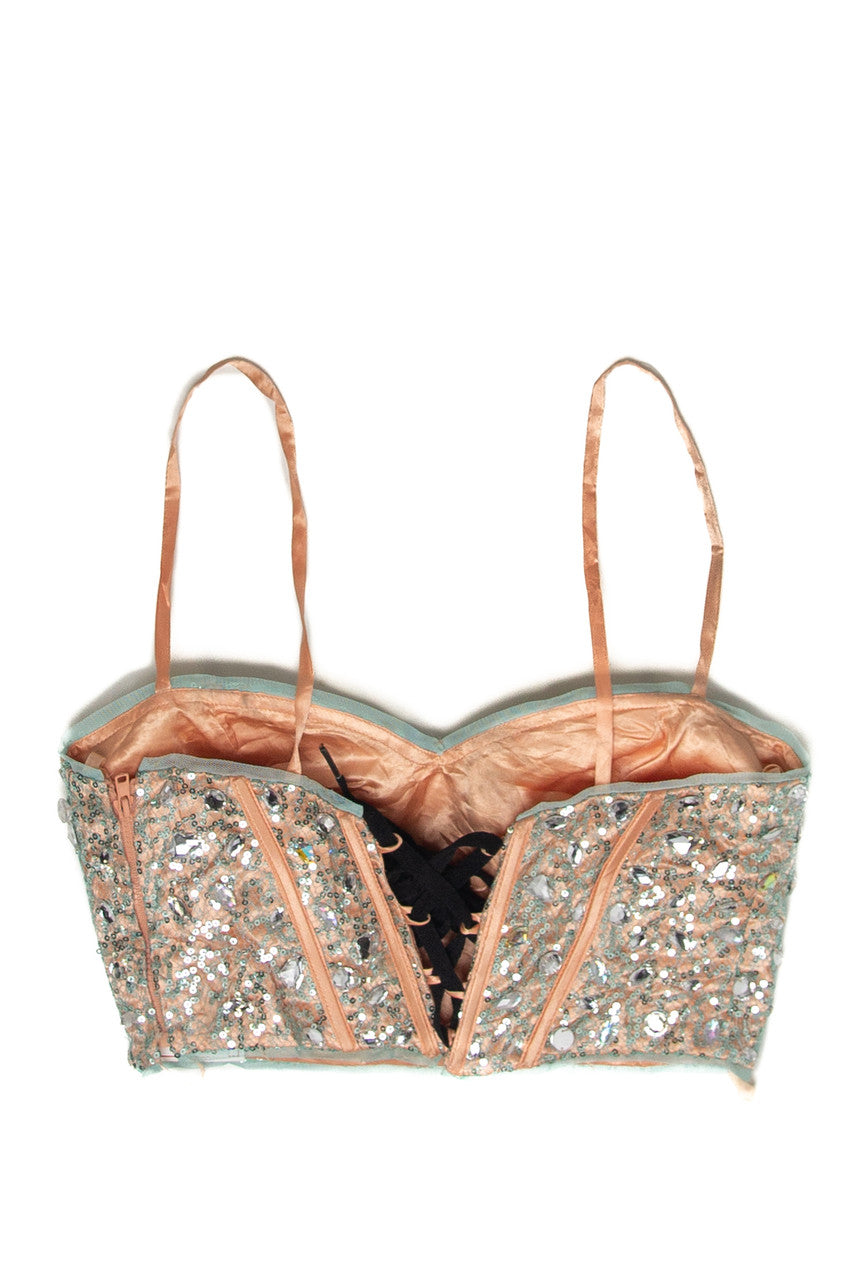Vintage Blondie sequin corset top with thin straps and intricate beadwork in a soft peach color on white background