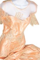Close-up of vintage 1980s pink satin formal dress with floral embroidery and lace details on sheer neckline and sleeves