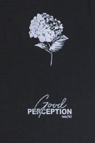 Black t-shirt with white floral design and 'Good Perception' text on a black background
