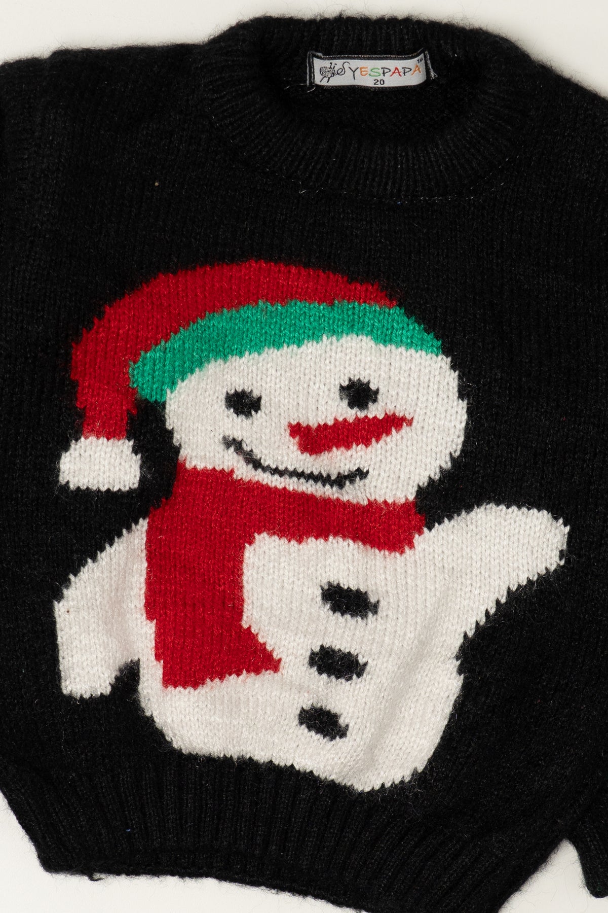 Black knit sweater featuring a smiling snowman in a red Santa hat and scarf by YESPAPA