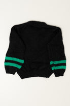 Back view of a black knit sweater with two green stripes on the sleeves