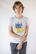 Man wearing a white speckled graphic t-shirt featuring the Saved by the Bell logo